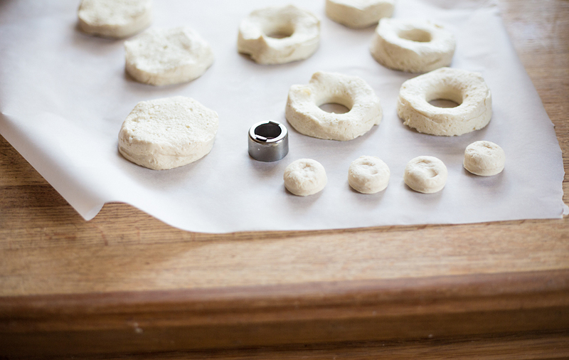 biscuits being cut with a donut cutter