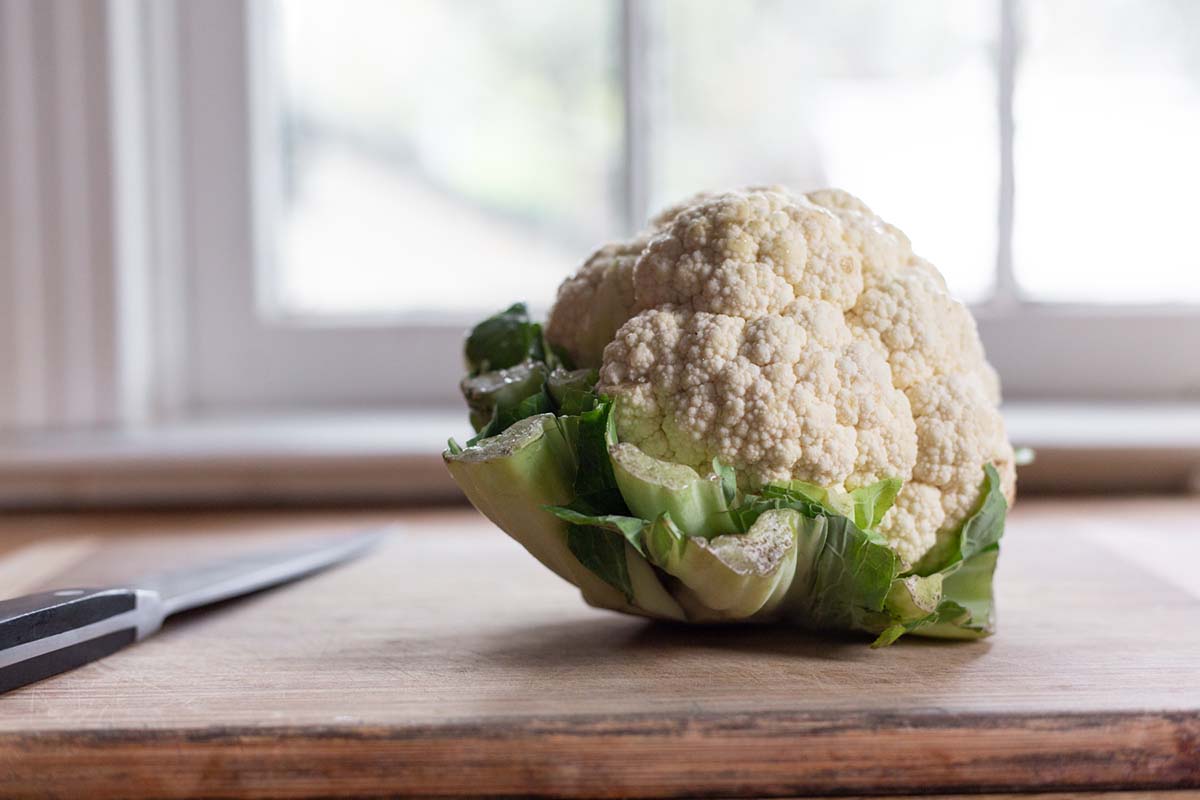 head of cauliflower on a cutting board