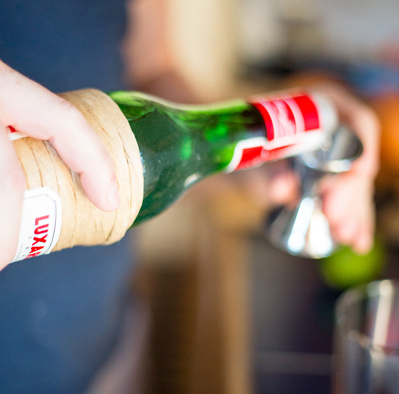 pouring luxardo for a cocktail