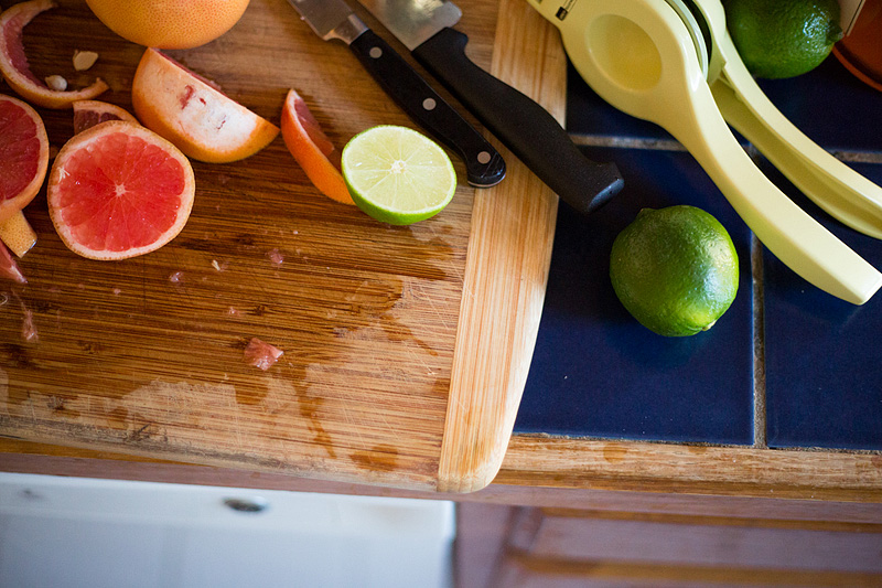 limes and grapefruit on a cutting board