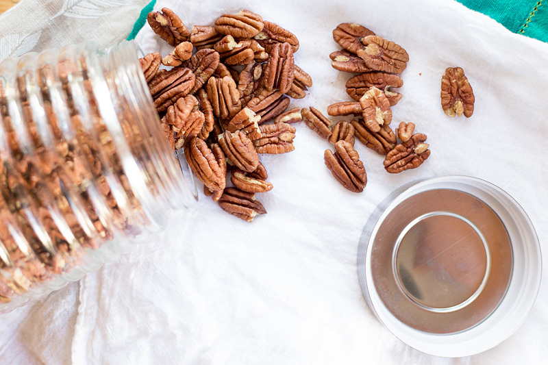 Pecans spilling out of a jar.