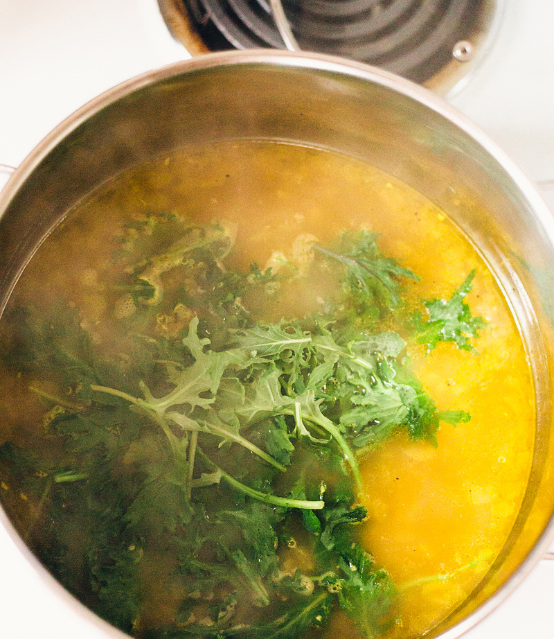 adding baby kale to the soup