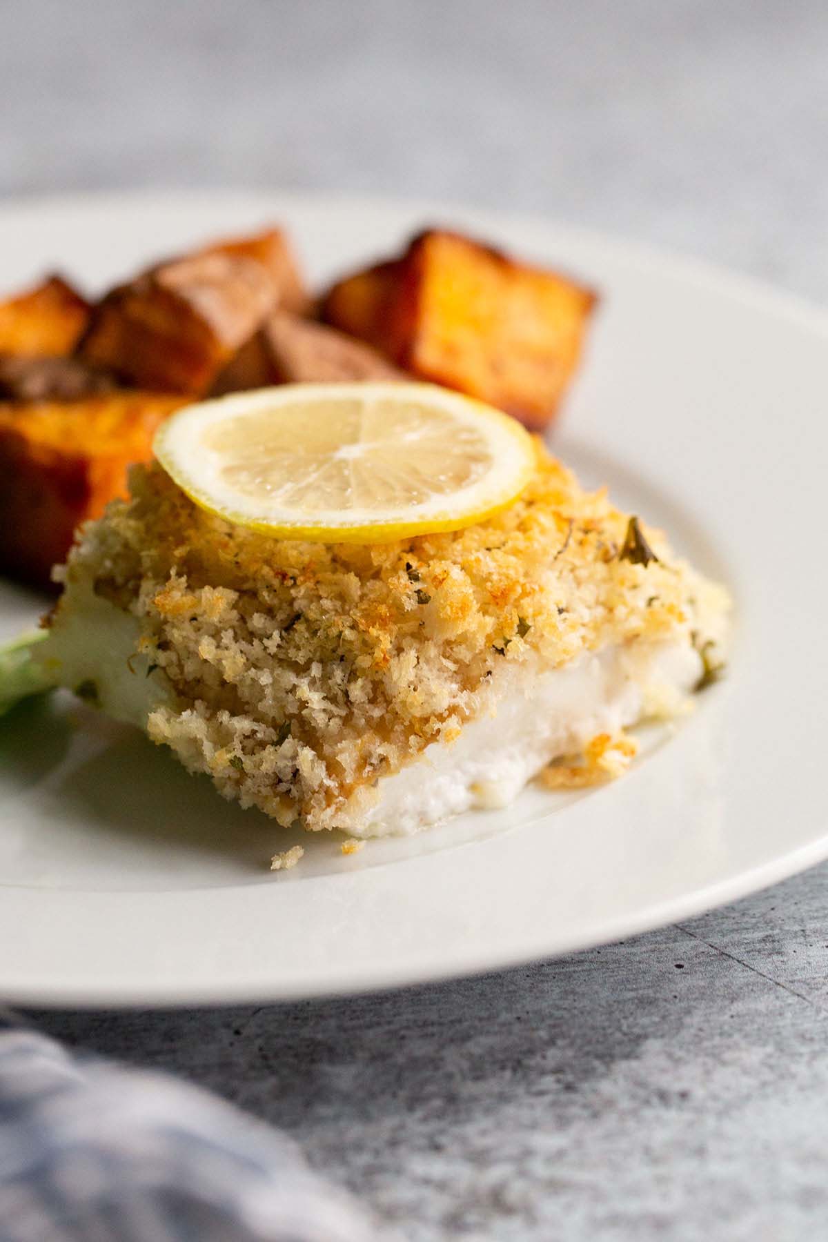 Panko parmesan cod with a lemon slice.