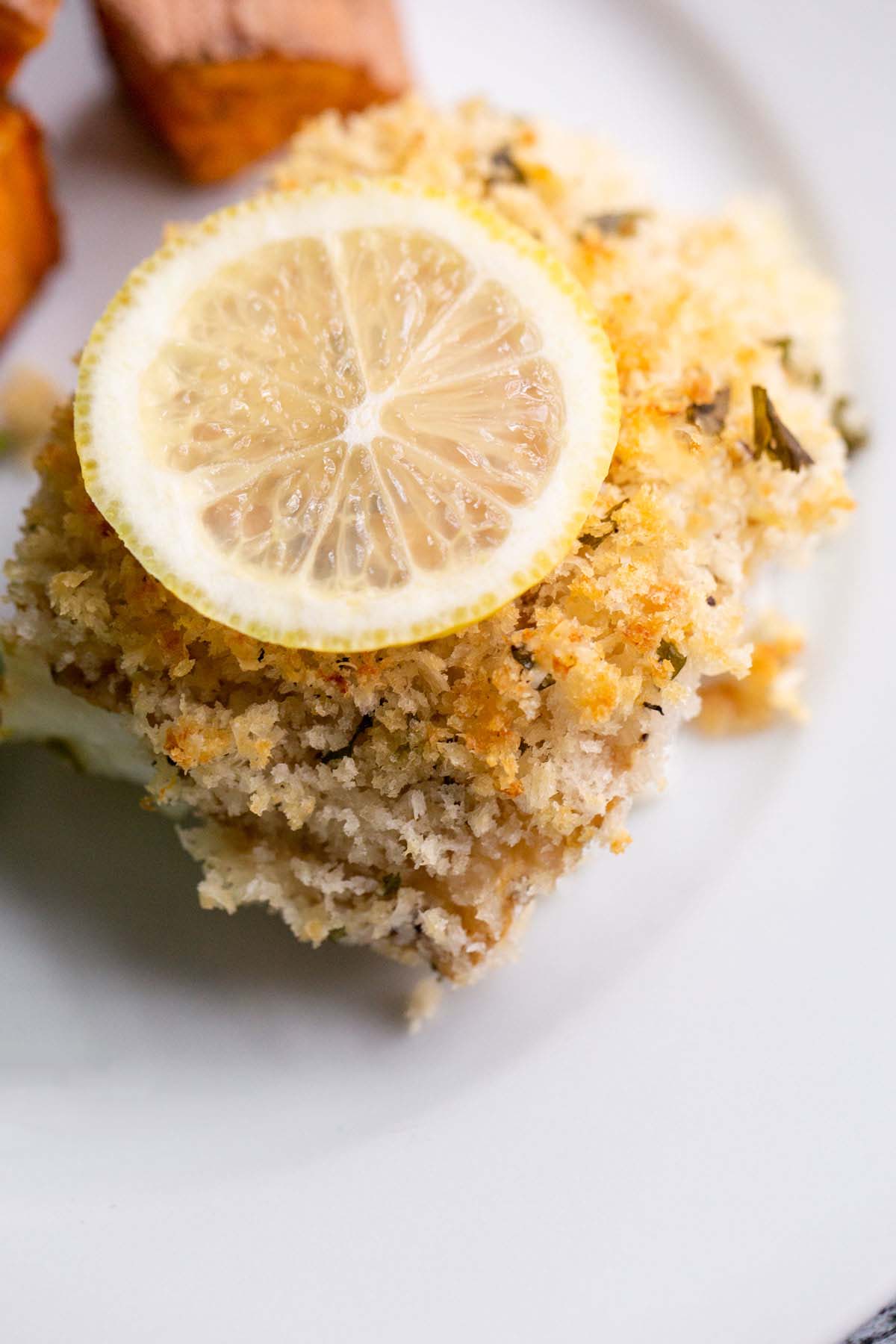 Panko parmesan cod with a lemon slice.
