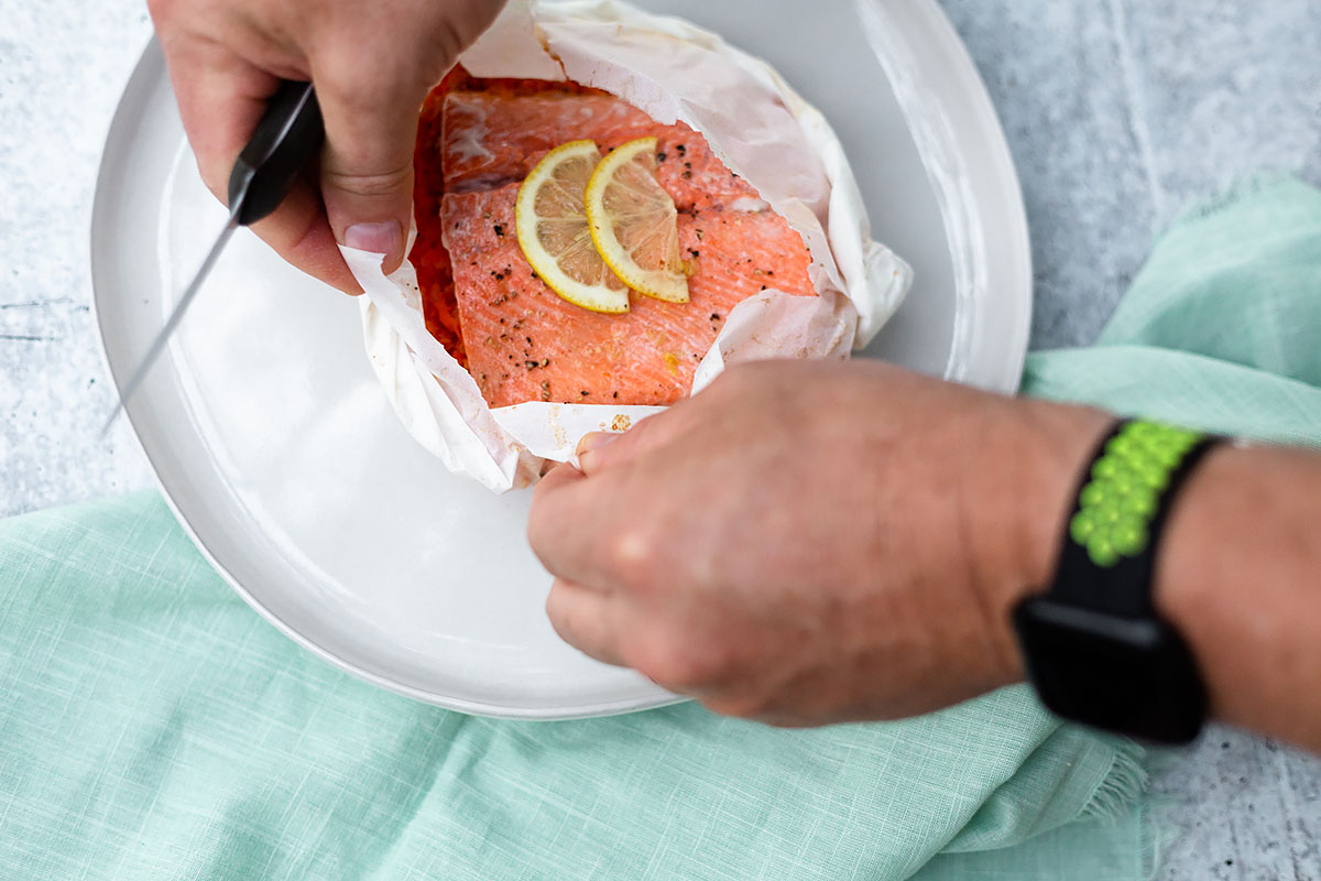 tearing open salmon in parchment