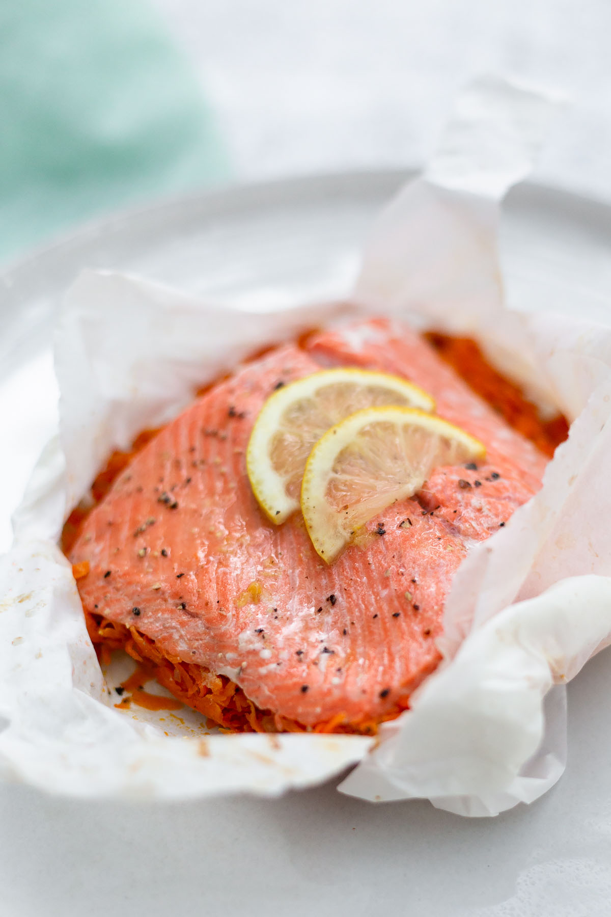 salmon in parchment up close with lemon slices