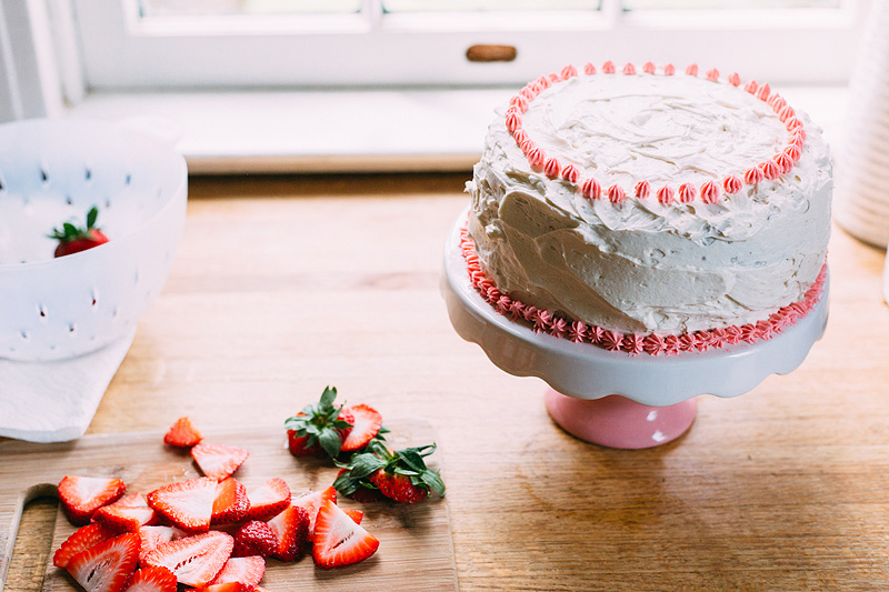 vanilla bean birthday cake with strawberries on the side.