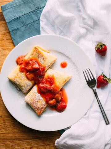 strawberry rhubarb blintzes on a plate