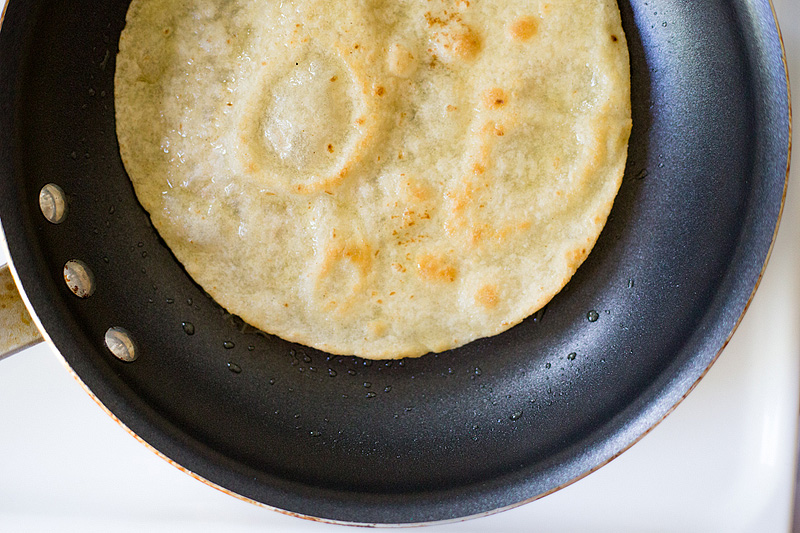 frying a tortilla in a skillet