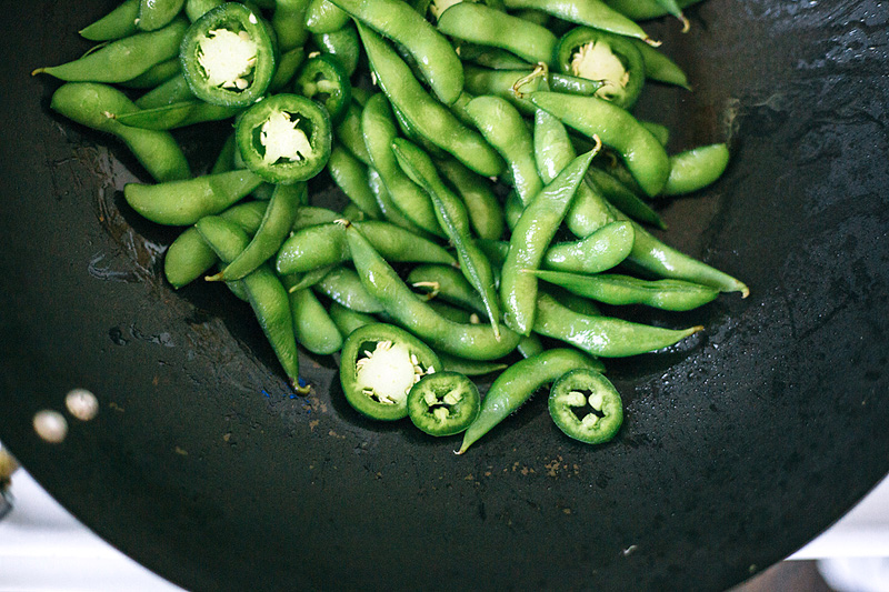 edamame and jalapenos in a wok