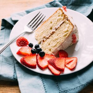 Vanilla bean birthday cake with fresh strawberries and blueberries.