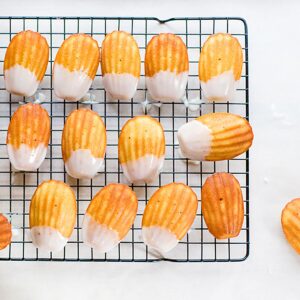 Lemon madeleine cookies on a cooling rack.