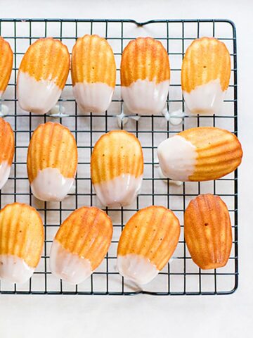 Lemon madeleine cookies on a cooling rack.