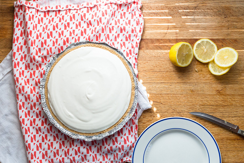 lemonade pie in the crust with lemons on the side