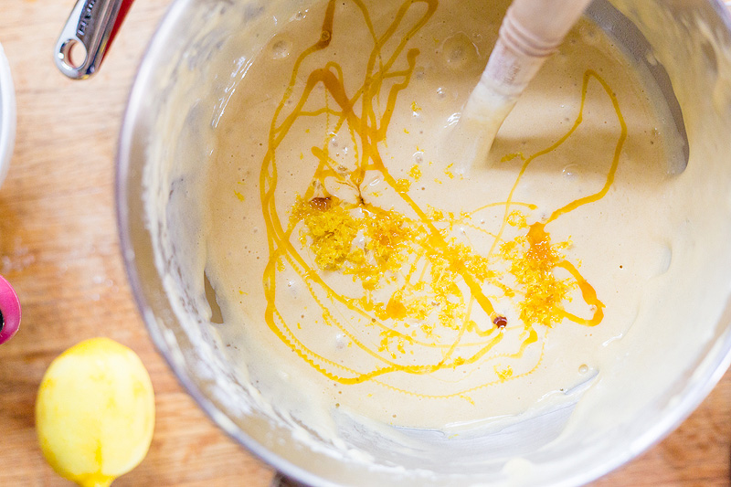 adding ingredients to lemon madeleine batter