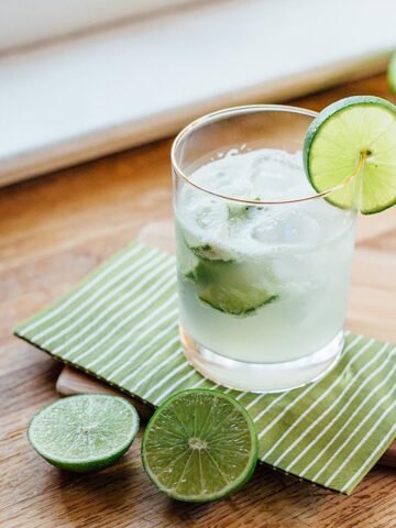 Caipirinha with a lime wedge.