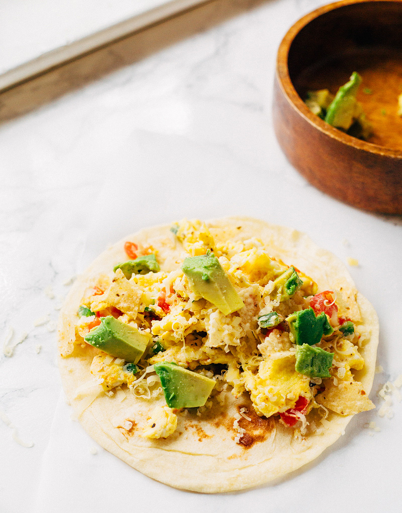 migas breakfast tacos topped with avocado and cheese