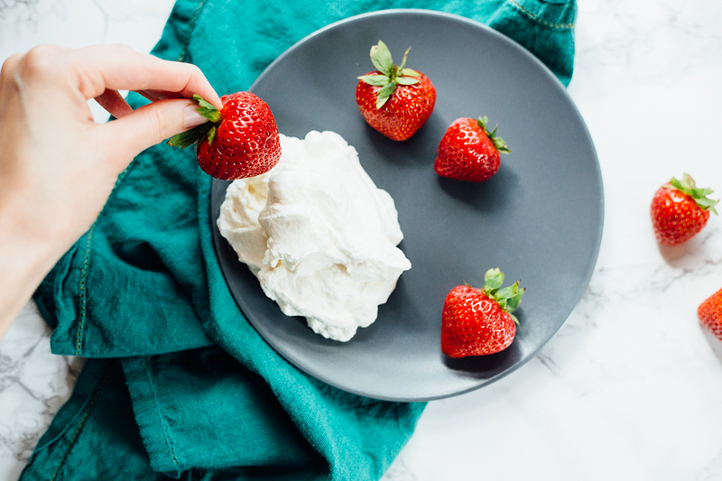 strawberries and whipped cream on a plate