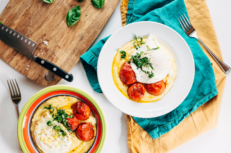 cheesy polenta with roasted tomatoes in two bowls