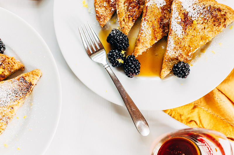 french toast for two with a fork and blackberries