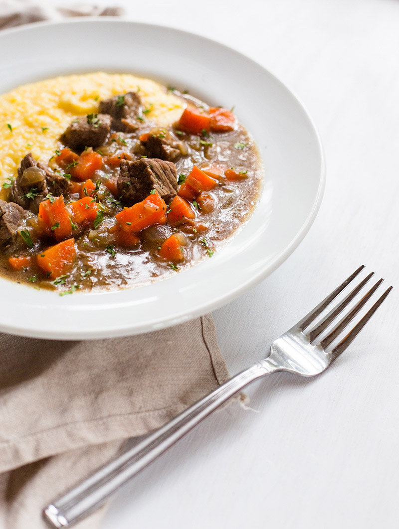 stew with parmesan polenta in a bowl