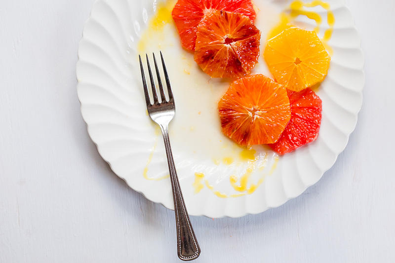 partially eaten citrus salad with a fork