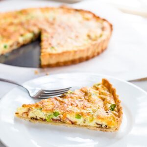 Slice of quiche on a plate.