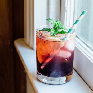 blackberry iced tea with a straw