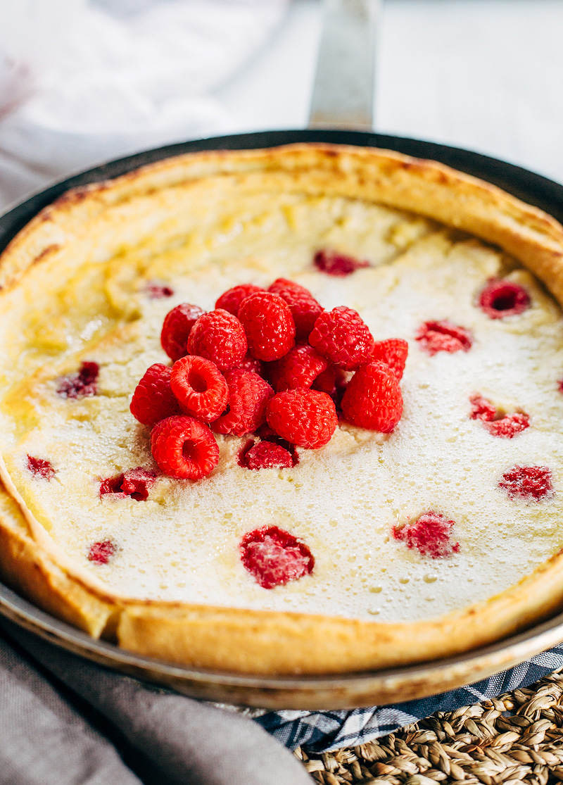 Raspberry Dutch Baby Pancake topped with fresh raspberries