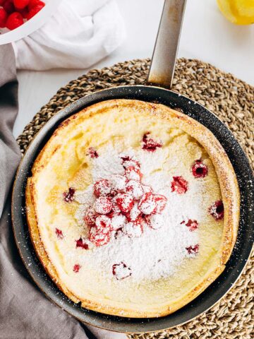 Raspberry dutch baby with powdered sugar