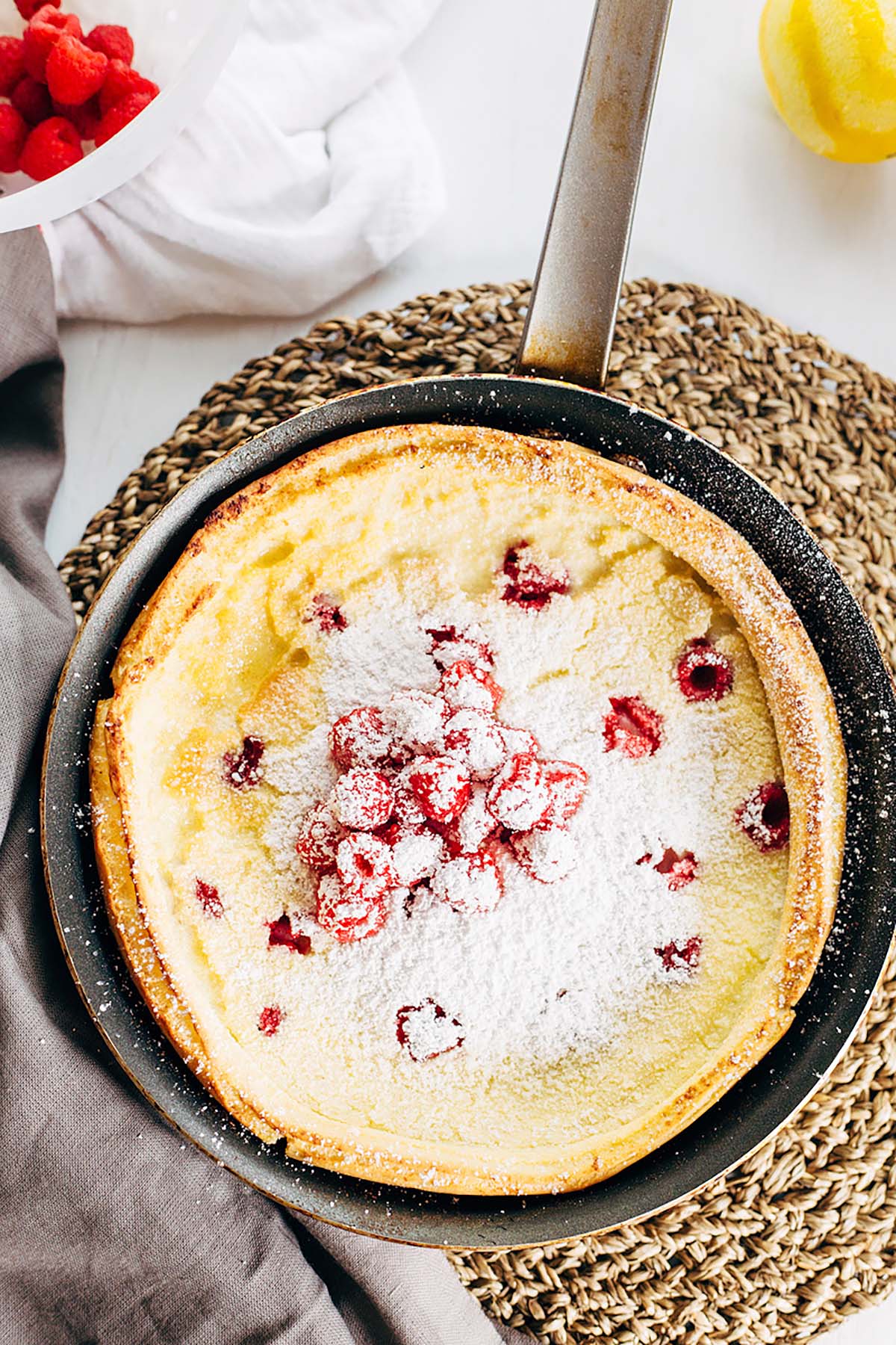 Raspberry dutch baby with powdered sugar