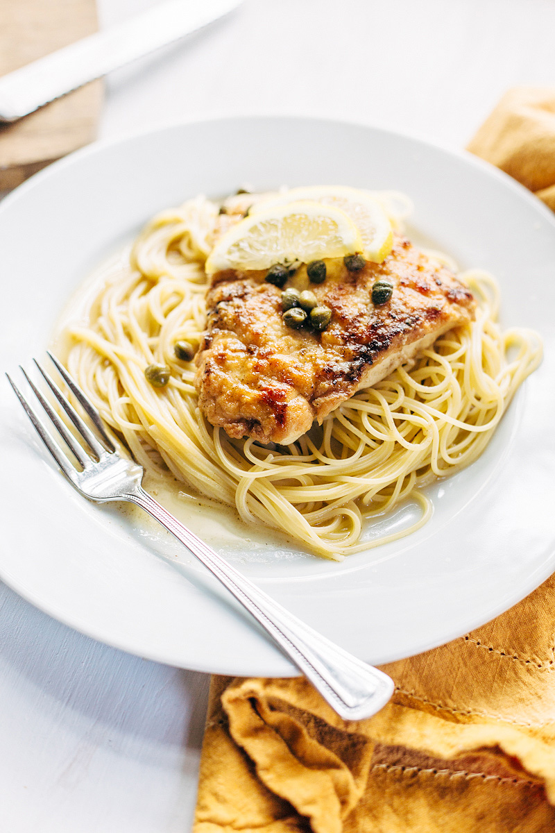 Chicken Piccata on a plate with angel hair pasta