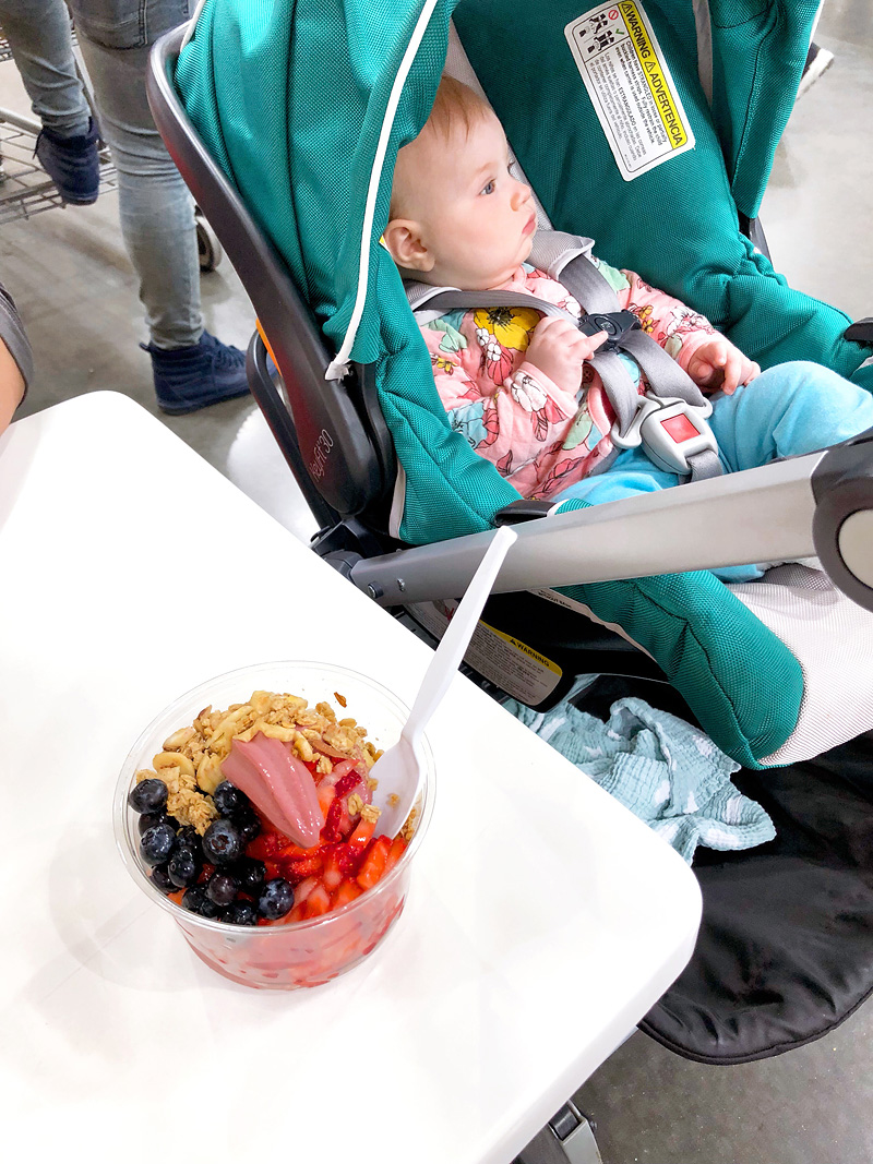 costco acai bowl and a baby in the background