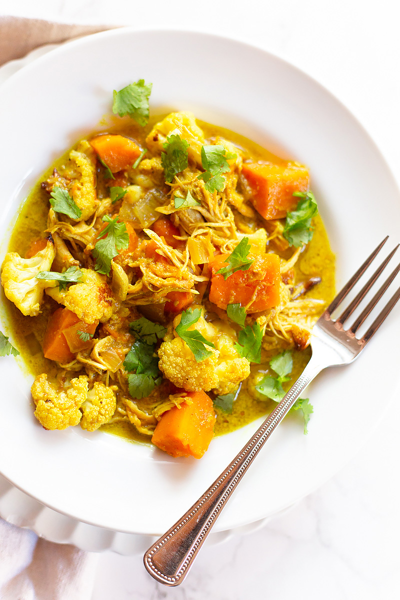 whole30 chicken curry with sweet potatoes in a white bowl