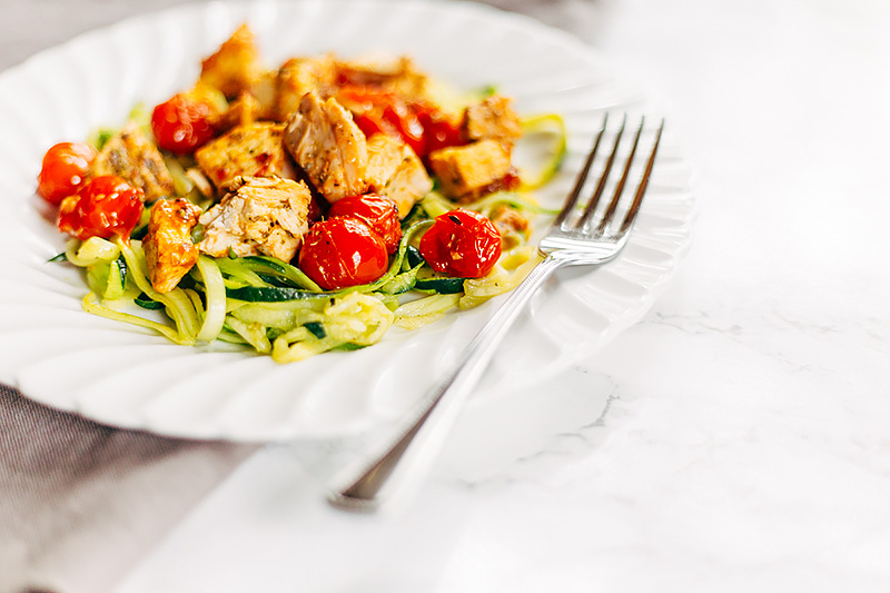 low carb Tomato Chicken Pasta with zucchini noodles on a plate with a fork