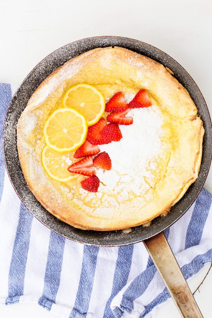 Lemon Dutch Baby Pancake Recipe with Powered Sugar and Strawberries