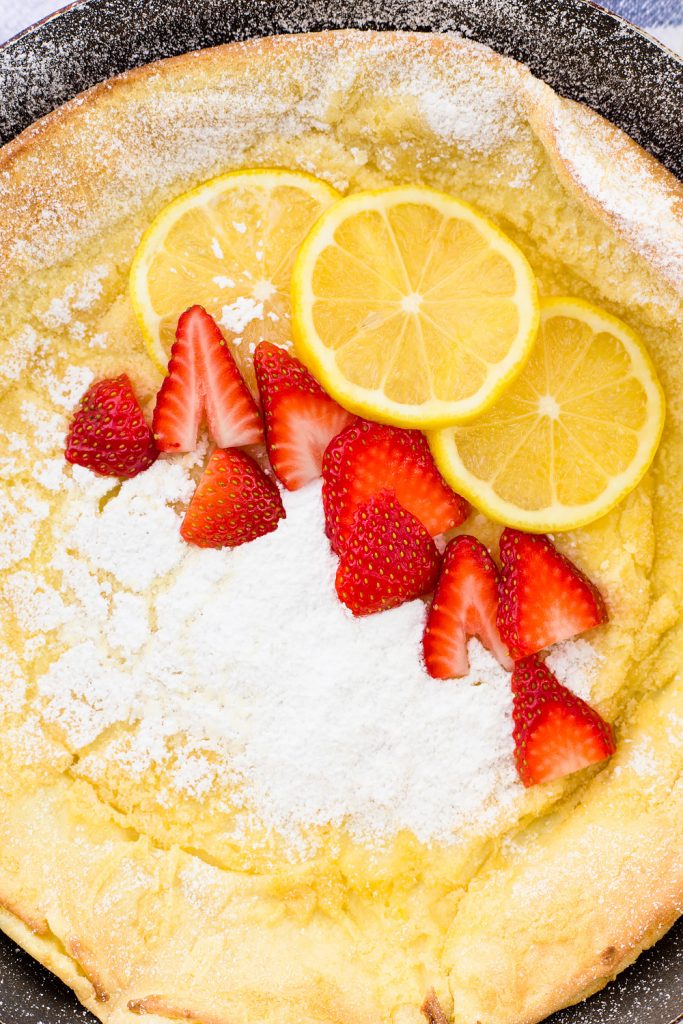 Lemon Dutch Baby Pancake Recipe with Powered Sugar and Strawberries