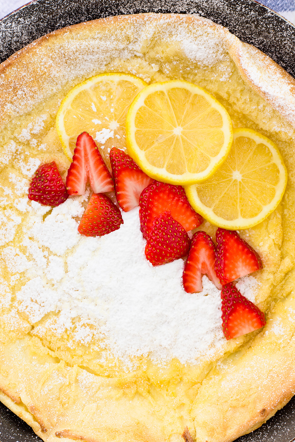 Lemon Dutch Baby Pancake with Powered Sugar and Strawberries