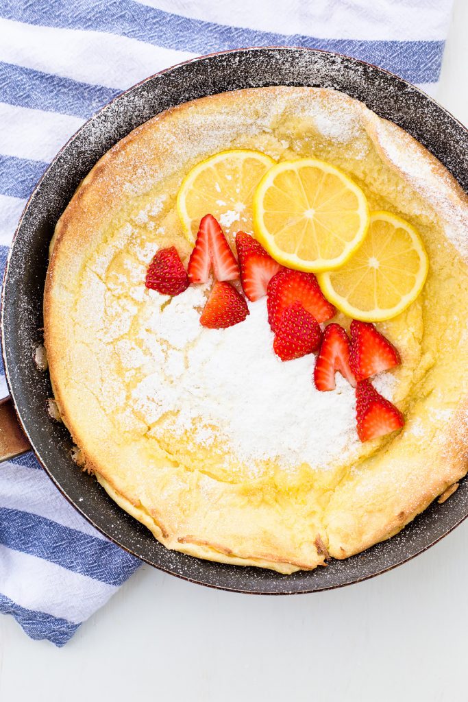 Lemon Dutch Baby Pancake Recipe with Powered Sugar and Strawberries