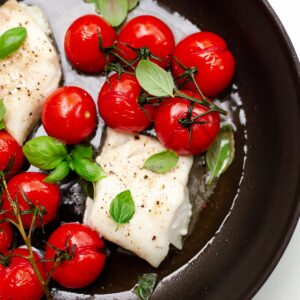Baked cod with tomatoes in a skiilet