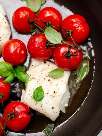 Baked cod with tomatoes in a skiilet