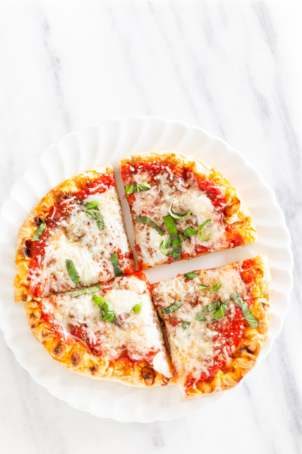 cut naan pizza on a plate