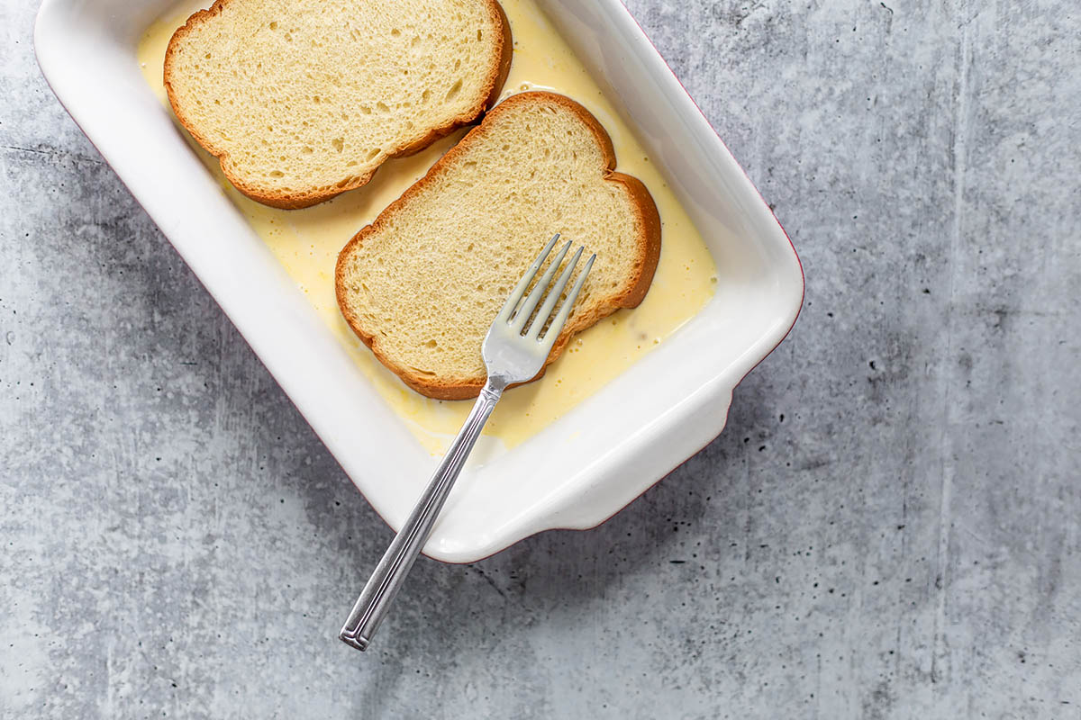 soaking bread in custard sauce.