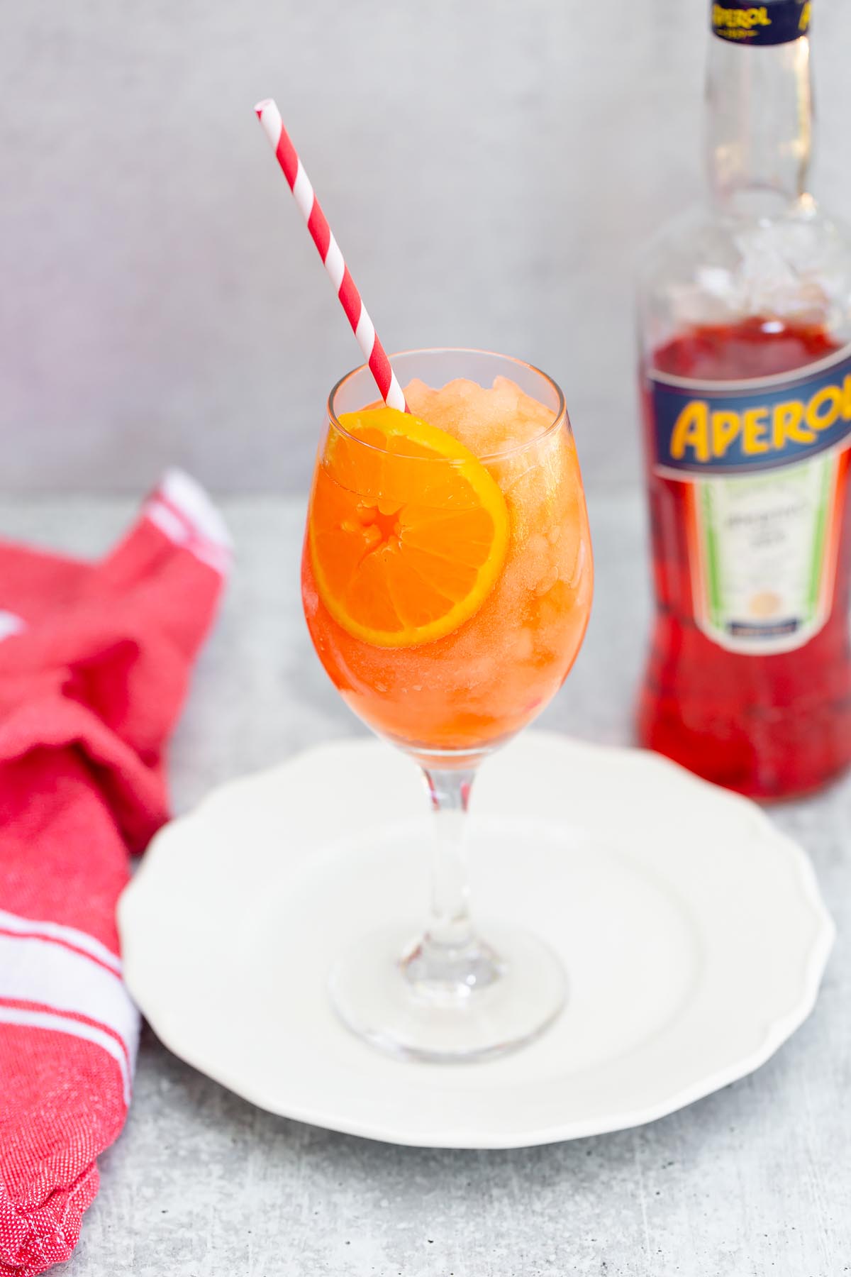 frozen aperol spritz with a bottle of aperol