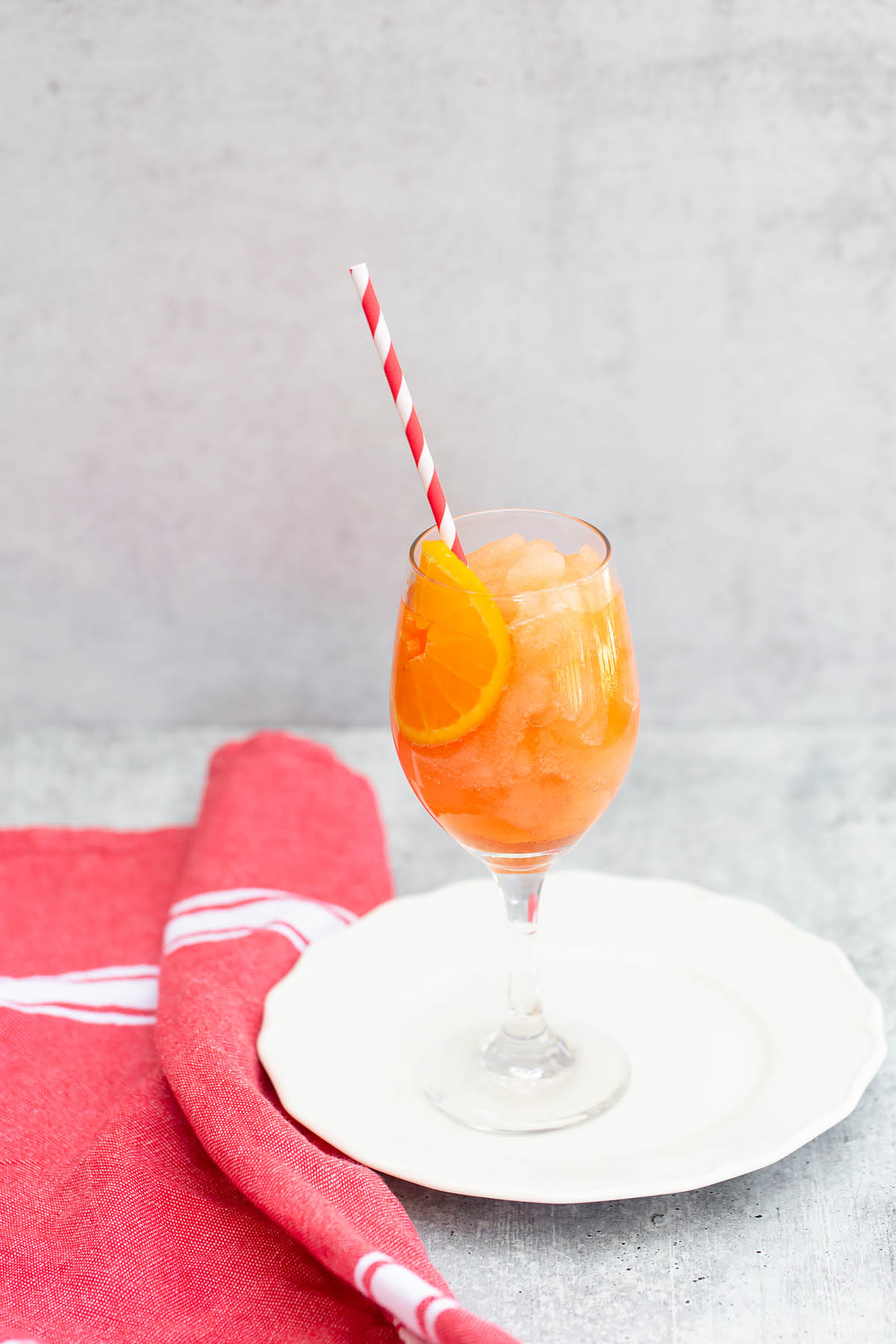 frozen aperol spritz with a straw