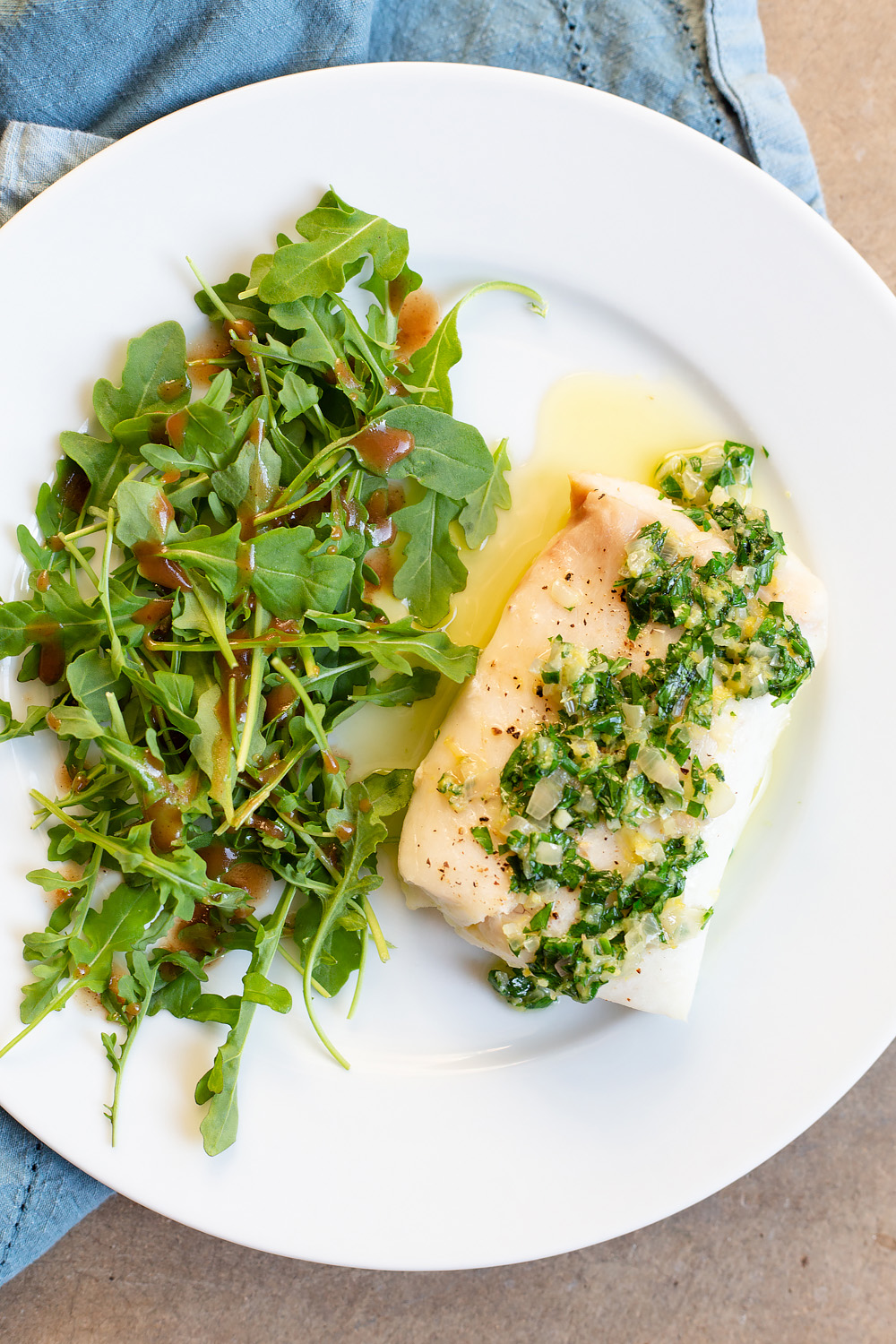 Cod with arugula salad on the side.