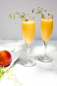 peach bellini mocktail with a peach on the side