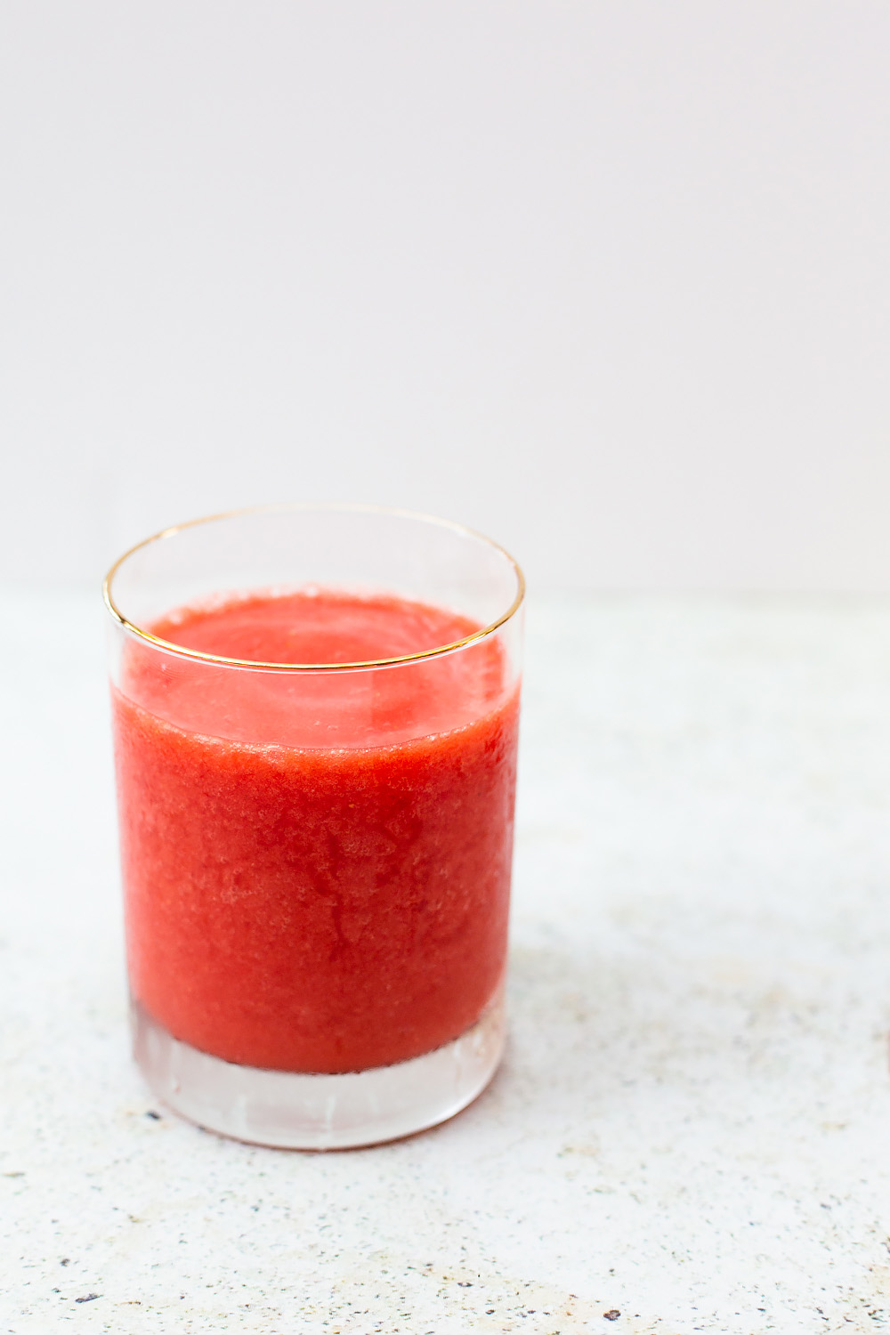 frozen strawberry slushie in a glass