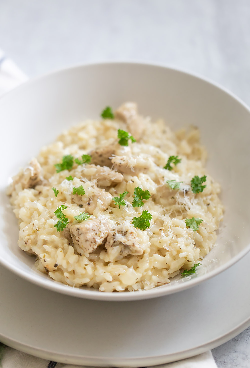 chicken and rice in a bowl topped with fresh parsley