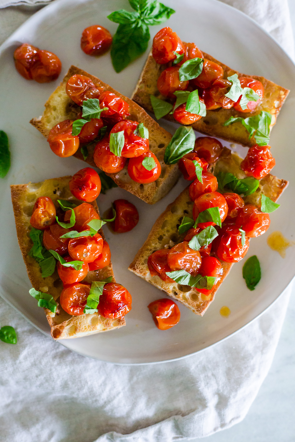 oven roasted tomatoes on toasted bread with fresh basil.